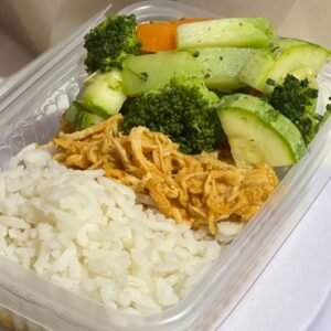 A nutritious meal prep box with rice, shredded chicken, and mixed vegetables.